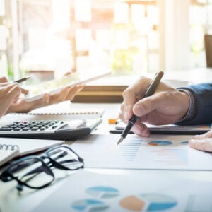 business man financial inspector and secretary making report calculating or checking balance. Internal Revenue Service inspector checking document. Audit concept