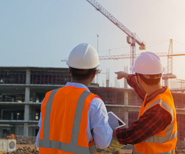 Two asian engineering using the tablet for discussion and working at construction on site