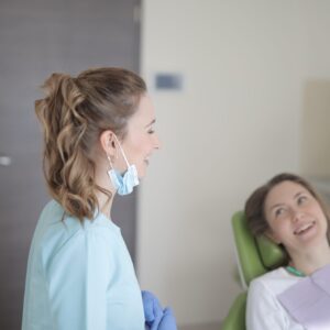 dentist and client in office for routine oral health exam